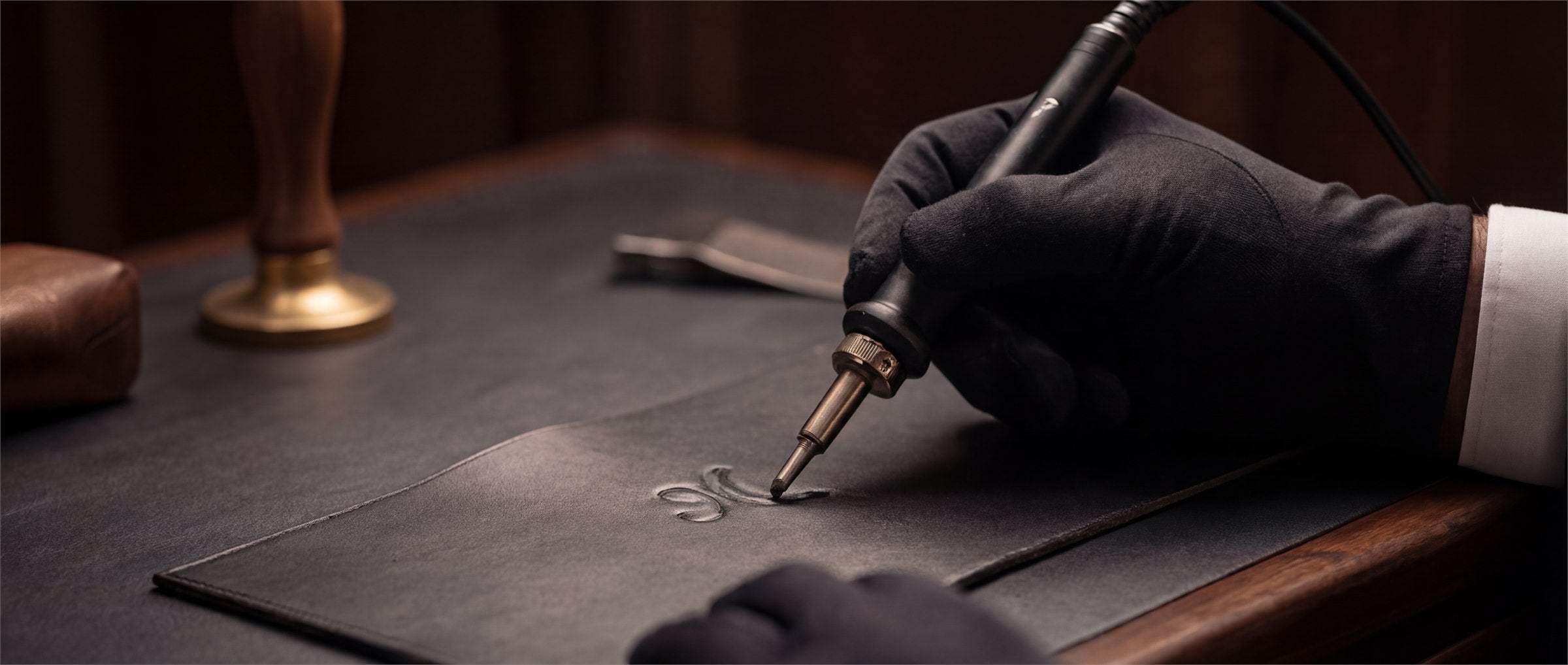 Personalization embossing in progress on a leather piece.