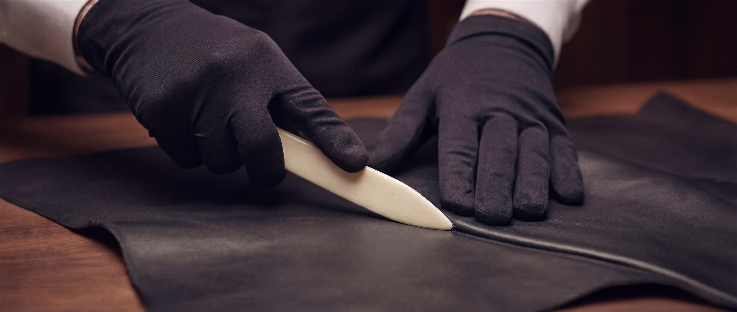 A controlled repair intervention being carried out on the structure of a leather piece.
